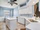 Bright kitchen with an island, white cabinets, modern appliances, and a cozy breakfast nook perfect for Gathering meals at 4206 Morning Breeze Ct, Tampa, FL 33619