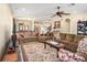 Spacious living room with elegant furnishings, ceiling fan, and seamless flow into the dining area at 4206 Morning Breeze Ct, Tampa, FL 33619