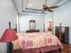 Spacious main bedroom with a tray ceiling, ceiling fan, and an ensuite bathroom at 4206 Morning Breeze Ct, Tampa, FL 33619