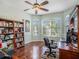 Bright office with large windows, hard wood floors, and a wooden bookshelf at 4206 Morning Breeze Ct, Tampa, FL 33619