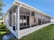 Enclosed patio with screen and sliding glass doors, seamlessly connecting indoor and outdoor living with beautiful green yard at 4206 Morning Breeze Ct, Tampa, FL 33619