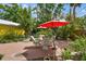Outdoor patio seating area with table, chairs, and red umbrella at 4462 2Nd S Ave, St Petersburg, FL 33711