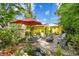 Outdoor patio with seating area, fish pond, and lush landscaping at 4462 2Nd S Ave, St Petersburg, FL 33711