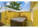 Private backyard deck featuring a hot tub and vibrant yellow exterior siding at 4462 2Nd S Ave, St Petersburg, FL 33711