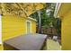 Private backyard featuring a hot tub, tropical plants, and yellow painted siding at 4462 2Nd S Ave, St Petersburg, FL 33711