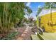 Backyard includes lush landscaping, stone paver path, and tropical plants at 4462 2Nd S Ave, St Petersburg, FL 33711