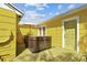 Private backyard with hot tub, wooden deck, and vibrant yellow home exterior at 4462 2Nd S Ave, St Petersburg, FL 33711
