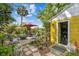 Serene backyard with brick patio, lush foliage, and outdoor seating around a fire pit at 4462 2Nd S Ave, St Petersburg, FL 33711