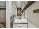 Stylish bathroom featuring a modern sink, unique wood accents, and open shelving at 4462 2Nd S Ave, St Petersburg, FL 33711