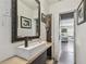 Modern bathroom with vessel sink, ornate mirror, and view to the living room at 4462 2Nd S Ave, St Petersburg, FL 33711