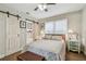 Cozy bedroom with barn door, soft lighting, and comfortable furnishings including a storage chest at 4462 2Nd S Ave, St Petersburg, FL 33711