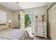 Bedroom with light walls, white dresser, and green door to outdoor deck at 4462 2Nd S Ave, St Petersburg, FL 33711