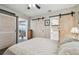 Bedroom features barn doors, wood look flooring, neutral decor, and an ensuite bath at 4462 2Nd S Ave, St Petersburg, FL 33711