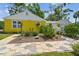 Charming single-story home with bright yellow exterior and well-maintained front yard at 4462 2Nd S Ave, St Petersburg, FL 33711