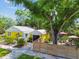 Charming yellow home with lush landscaping and a beautiful, mature shade tree at 4462 2Nd S Ave, St Petersburg, FL 33711