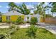 Exterior view of the charming home featuring a well-maintained front yard and attached garage at 4462 2Nd S Ave, St Petersburg, FL 33711