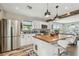Modern kitchen features white cabinets, stainless steel appliances, wooden countertops, and pendant lighting at 4462 2Nd S Ave, St Petersburg, FL 33711