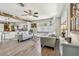 Bright living room with wood beam, ceiling fan, and updated floors flowing into an open kitchen at 4462 2Nd S Ave, St Petersburg, FL 33711