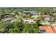 An aerial view of a residential neighborhood with mature trees and a beautiful lake at 4677 Del Sol Blvd, Sarasota, FL 34243