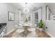 Breakfast nook features modern light fixture and table setting, and pool view at 4677 Del Sol Blvd, Sarasota, FL 34243