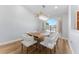Dining room featuring unique wood table, modern chandelier, and natural light from window at 4677 Del Sol Blvd, Sarasota, FL 34243
