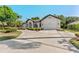 Beautiful white brick home with a well-manicured lawn and a spacious concrete driveway at 4677 Del Sol Blvd, Sarasota, FL 34243
