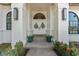 Grand entrance with double doors, sidelights, brick columns, and manicured landscaping at 4677 Del Sol Blvd, Sarasota, FL 34243