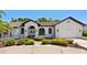 Charming home featuring white brick, arched windows, double-door entry, and lush landscaping at 4677 Del Sol Blvd, Sarasota, FL 34243