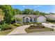 Well-maintained home featuring a circular driveway, lush landscaping, and a serene atmosphere at 4677 Del Sol Blvd, Sarasota, FL 34243