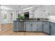 Kitchen with bar features stainless appliances, two-tone cabinets, and wood flooring at 4677 Del Sol Blvd, Sarasota, FL 34243