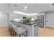 Kitchen with bar features stainless appliances, two-tone cabinets, and wood flooring at 4677 Del Sol Blvd, Sarasota, FL 34243