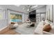 Staged living room with modern furniture, stylish shelving, and a view of the pool area at 4677 Del Sol Blvd, Sarasota, FL 34243