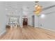 Spacious interior featuring wood floors, an open layout, and modern light fixtures at 4677 Del Sol Blvd, Sarasota, FL 34243
