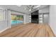 Living room features a built-in entertainment center and sliding glass doors to the pool at 4677 Del Sol Blvd, Sarasota, FL 34243