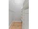 A walk-in closet with built-in shelving and wooden floor at 4677 Del Sol Blvd, Sarasota, FL 34243