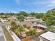 Aerial view of a property featuring a pool, fenced yard, outdoor patio, and mature trees at 4815 Plantation Dr, Tampa, FL 33615
