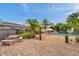 Landscaped backyard with a brick paver patio, complete with a dining table, leading to a tranquil pool area at 4815 Plantation Dr, Tampa, FL 33615