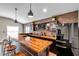 Stylish bar area with a wood countertop, brick wall, and modern appliances, perfect for entertaining guests and relaxation at 4815 Plantation Dr, Tampa, FL 33615