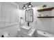 Modern bathroom with vessel sink, floating shelves, and updated fixtures at 4815 Plantation Dr, Tampa, FL 33615