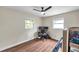Bright bedroom with wood-look floors, lots of natural light, and updated ceiling fan at 4815 Plantation Dr, Tampa, FL 33615