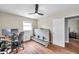Comfortable bedroom with wood-look floors, lots of natural light, and updated ceiling fan and fixtures at 4815 Plantation Dr, Tampa, FL 33615