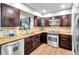 Updated kitchen with stainless steel appliances, granite countertops, and wood cabinetry, offering a modern and efficient space at 4815 Plantation Dr, Tampa, FL 33615