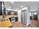 Modern kitchen with stainless steel appliances, granite countertops, and wood cabinetry, leading to an open living space at 4815 Plantation Dr, Tampa, FL 33615