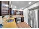 Well-lit kitchen with stainless steel appliances, granite countertops, and wood cabinetry, blending style and functionality at 4815 Plantation Dr, Tampa, FL 33615
