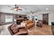 Open living room featuring a stylish bar, hardwood floors, and comfortable seating, perfect for entertaining and relaxation at 4815 Plantation Dr, Tampa, FL 33615