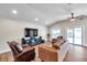Open living room with hardwood floors, modern furnishings, and lots of natural light at 4815 Plantation Dr, Tampa, FL 33615