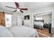 Spacious main bedroom with closet mirror doors, updated ceiling fan, private bathroom, and wood look floors at 4815 Plantation Dr, Tampa, FL 33615