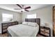 Comfortable main bedroom with wood-look floors, lots of natural light, updated ceiling fan, and rustic accents at 4815 Plantation Dr, Tampa, FL 33615