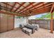 Outdoor patio space featuring a conversation set, ceiling fan, a privacy screen, and a well-maintained brick paver floor at 4815 Plantation Dr, Tampa, FL 33615