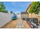 Side yard featuring a kayak rack, storage shed, and stone pathway behind a white fence at 4815 Plantation Dr, Tampa, FL 33615
